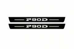 Catalogue illustration of two front black Matte PRO LED door sill plates with illuminated P90D lettering for Tesla Model S; dimensions are selected during manufacture.