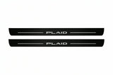 Catalogue illustration of two front black Matte PRO LED door sill plates with illuminated PLAID lettering for Tesla Model S; dimensions are selected during manufacture.