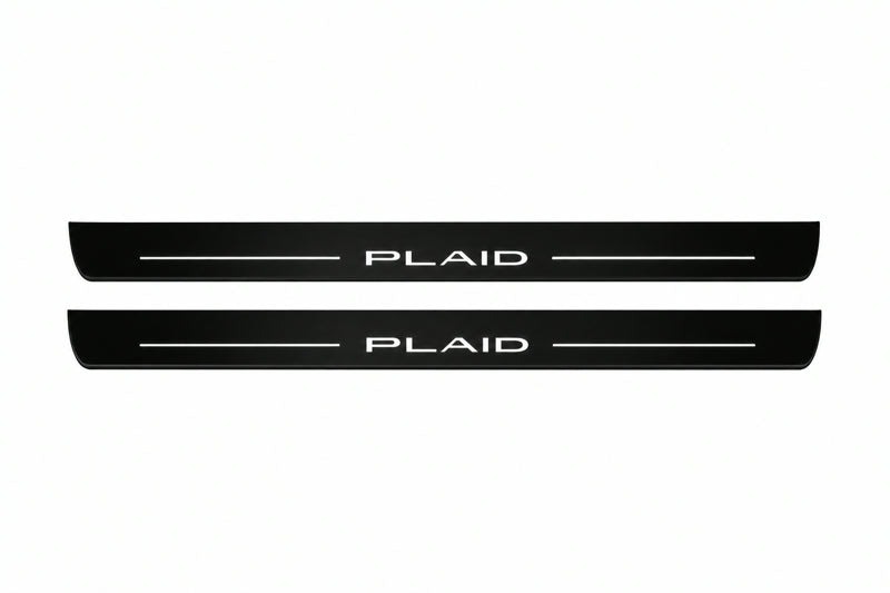 Catalogue illustration of two front black Matte PRO LED door sill plates with illuminated PLAID lettering for Tesla Model S; dimensions are selected during manufacture.