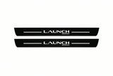 Catalogue illustration of two front black Matte PRO LED door sill plates with illuminated Launch Series lettering for Tesla Model Y Juniper; dimensions are selected during manufacture.