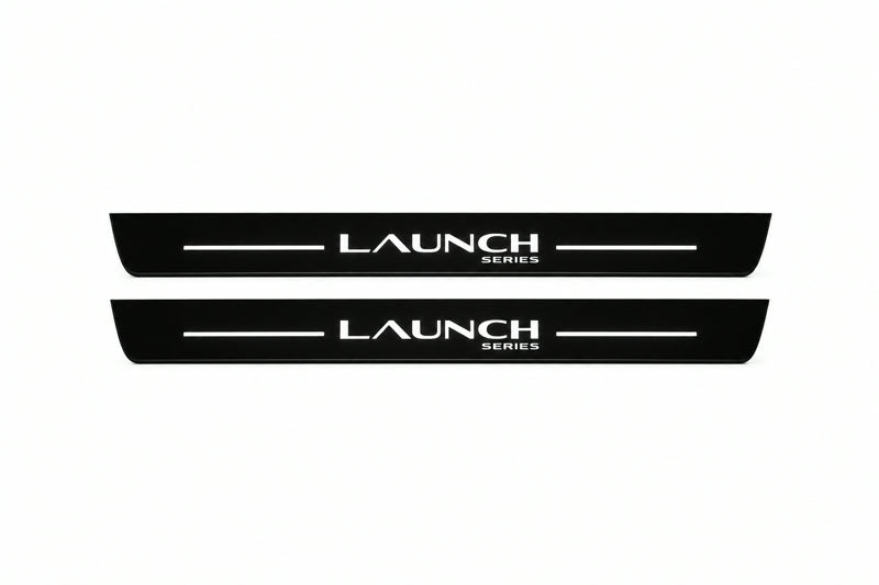 Catalogue illustration of two front black Matte PRO LED door sill plates with illuminated Launch Series lettering for Tesla Model Y Juniper; dimensions are selected during manufacture.