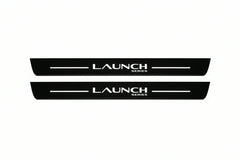 Catalogue illustration of two front black Matte PRO LED door sill plates with illuminated Launch Series lettering for Tesla Model Y Juniper; dimensions are selected during manufacture.