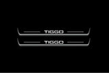 Two long door sill plates with Tiggo lettering and edges illuminated in white, straight-on view on a dark background.