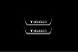 Two short door sill plates with Tiggo lettering and edges illuminated in white, straight-on view on a dark background.