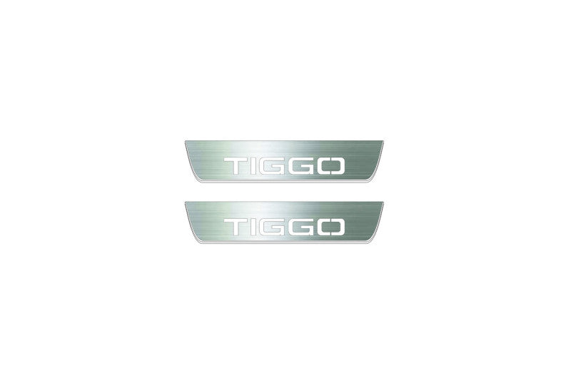 Two short silver-finished door sill plates with Tiggo lettering on a light background, straight-on view.