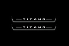 Two long door sill plates with Titano lettering and edges illuminated in white, straight-on view on a dark background.