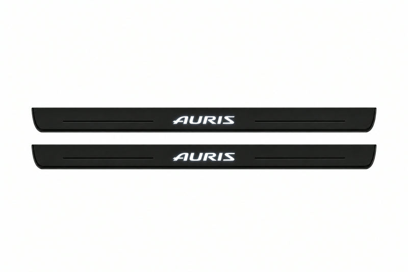 Catalogue illustration of two front black Matte PRO LED door sill plates with illuminated Auris lettering for Toyota Auris II E180; dimensions are selected during manufacture.