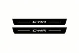Catalogue illustration of two front black Matte PRO LED door sill plates with illuminated C-HR lettering for Toyota C-HR I; dimensions are selected during manufacture.