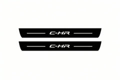 Catalogue illustration of two front black Matte PRO LED door sill plates with illuminated C-HR lettering for Toyota C-HR I; dimensions are selected during manufacture.