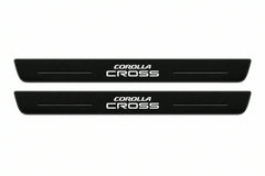 Catalogue illustration of two front black Matte PRO LED door sill plates with illuminated Corolla Cross lettering for Toyota Corolla Cross XG10; dimensions are selected during manufacture.