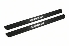 Catalogue illustration of two front black Matte PRO LED door sill plates with illuminated Corolla lettering for Toyota Corolla XI E160; dimensions are selected during manufacture.