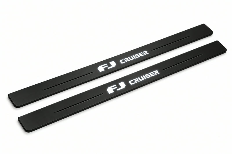 Catalogue illustration of two front black Matte PRO LED door sill plates with illuminated FJ Cruiser lettering for Toyota FJ Cruiser XJ10; dimensions are selected during manufacture.