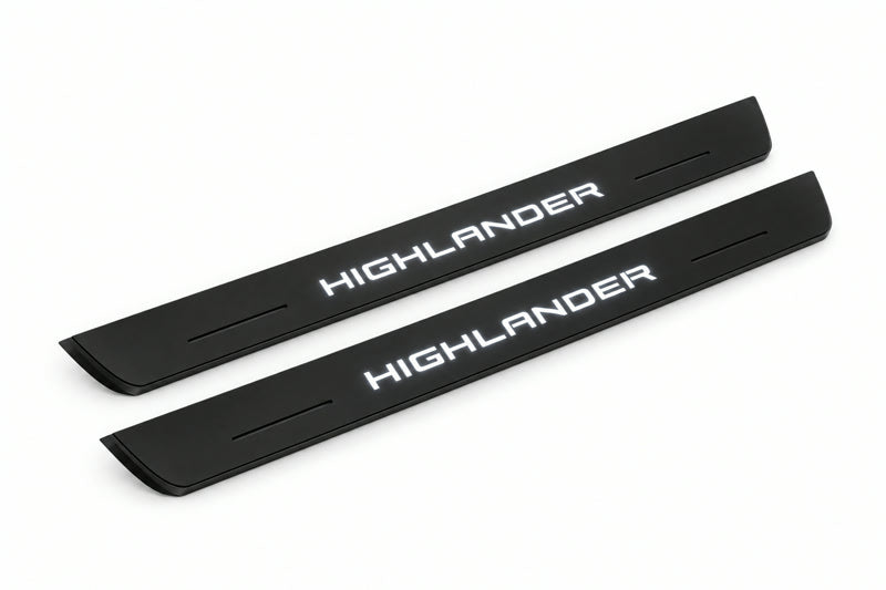 Catalogue illustration of two front black Matte PRO LED door sill plates with illuminated Highlander lettering for Toyota Highlander XU70; dimensions are selected during manufacture.