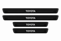 Catalogue illustration of two long front and two short rear black Matte PRO sill plates with illuminated TOYOTA lettering only on top, unlit horizontal grooves and opaque side edges. Actual dimensions selected for Land Cruiser 250 J250 during manufacture.