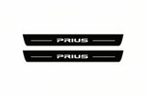 Catalogue illustration of two front black Matte PRO LED door sill plates with illuminated Prius lettering for Toyota Prius XW30; dimensions are selected during manufacture.