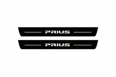 Catalogue illustration of two front black Matte PRO LED door sill plates with illuminated Prius lettering for Toyota Prius XW30; dimensions are selected during manufacture.
