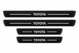 Catalogue illustration of two long front and two shorter rear black Matte PRO door sill plates with illuminated TOYOTA lettering and straight top lines; edges unlit. Exact RAV4 XA50 dimensions are selected for the vehicle.