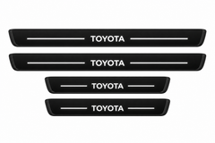 Catalogue illustration of two long front and two shorter rear black Matte PRO door sill plates with illuminated TOYOTA lettering and straight top lines; edges unlit. Exact RAV4 XA50 dimensions are selected for the vehicle.