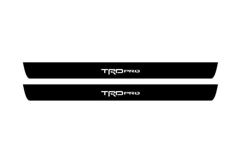 Catalog illustration of two black front door sill plates with TRD Pro lettering.