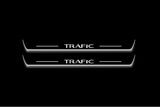 Two long door sill plates with Trafic lettering and edges illuminated in white, straight-on view on a dark background.
