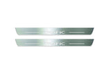 Two long silver-finished door sill plates with Trafic lettering on a light background, straight-on view.