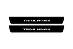 Catalog illustration of two black front door sill plates with Trailhawk lettering.