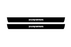 Catalog illustration of two black front door sill plates with TRANSFORMERS lettering.