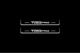 Toyota Tacoma IV 2024+ illuminated entry guards in stainless steel with TRD pro logo