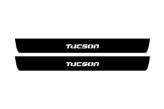 Catalog illustration of two black front door sill plates with Tucson lettering.