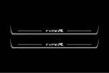 Two long door sill plates with Type R lettering and edges illuminated in white, straight-on view on a dark background.