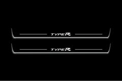Two long door sill plates with Type R lettering and edges illuminated in white, straight-on view on a dark background.