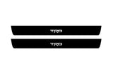 Toyota Camry V50 2012+ illuminated door sill protectors in matte black coated stainless steel with TRD logo