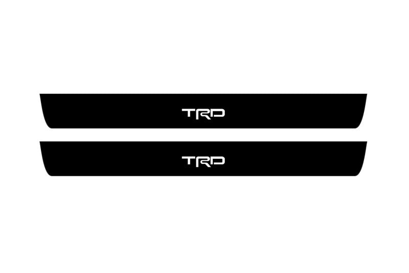 Toyota Camry V50 2012+ illuminated door sill protectors in matte black coated stainless steel with TRD logo