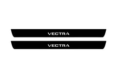 Catalog illustration of two black front door sill plates with Vectra lettering.
