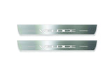 Two long silver-finished door sill plates with Veloce lettering on a light background, straight-on view.