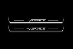 Two long door sill plates with Vignale lettering and edges illuminated in white, straight-on view on a dark background.