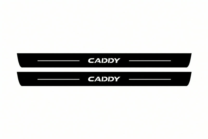 Catalogue illustration of two front black Matte PRO LED door sill plates with illuminated Caddy lettering for Volkswagen Caddy Van SB; dimensions are selected during manufacture.