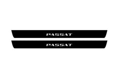 Catalog illustration of two black front door sill plates with Passat lettering.