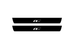 Catalog illustration of two black front door sill plates with R-Line lettering.