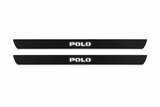 Catalogue illustration of two black Matte PRO front door sill plates with white POLO lettering illuminated only on top. Edges are unlit; rear plates for FRONT+REAR are not pictured. Final dimensions are selected for Polo V during manufacture.
