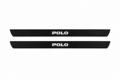 Catalogue illustration of two black Matte PRO front door sill plates with white POLO lettering illuminated only on top. Edges are unlit; rear plates for FRONT+REAR are not pictured. Final dimensions are selected for Polo V during manufacture.