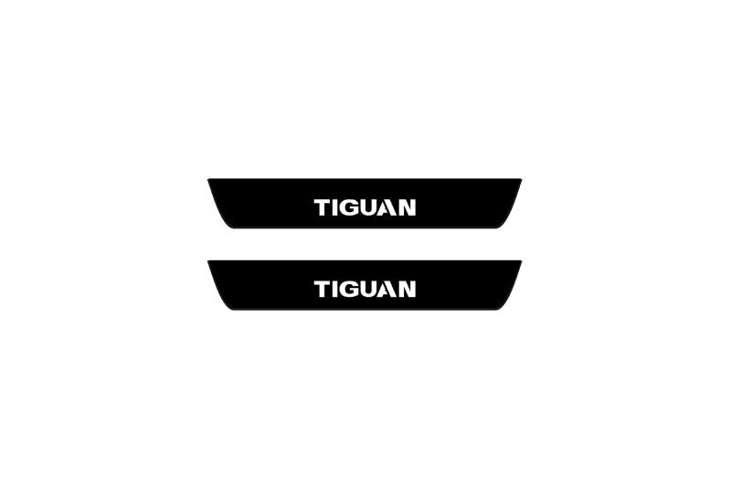 Catalog illustration of two black rear door sill plates with Tiguan lettering.
