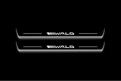 Two long door sill plates with Wald lettering and edges illuminated in white, straight-on view on a dark background.