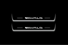 Two long door sill plates with Wald lettering and edges illuminated in white, straight-on view on a dark background.