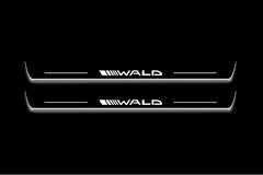 Two long door sill plates with Wald lettering and edges illuminated in white, straight-on view on a dark background.