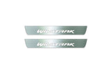 Two short silver-finished door sill plates with Wildtrak lettering on a light background, straight-on view.