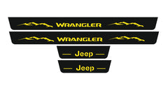 Catalog illustration of four black door sill plates: yellow Wrangler lettering with mountain graphics on the long pair and Jeep lettering on the short pair.