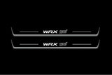 Two long door sill plates with WRX STI lettering and edges illuminated in white, straight-on view on a dark background.