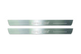 Two long silver-finished door sill plates with WRX STI lettering on a light background, straight-on view.