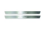 Two long silver-finished door sill plates with WRX STI lettering on a light background, straight-on view.